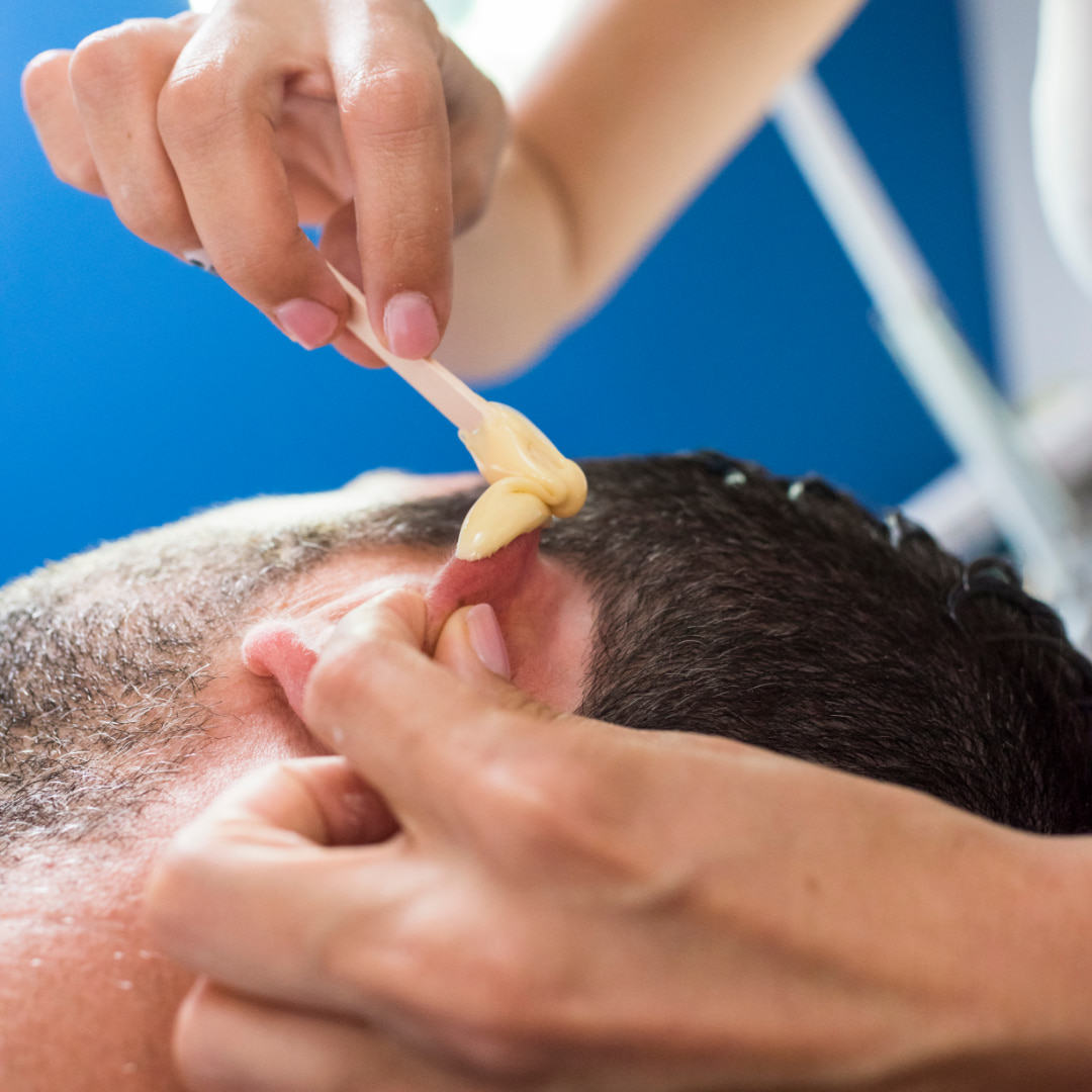 young man having ear waxing