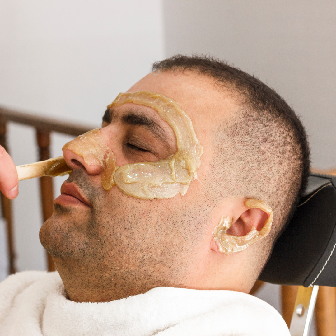 man having face waxing