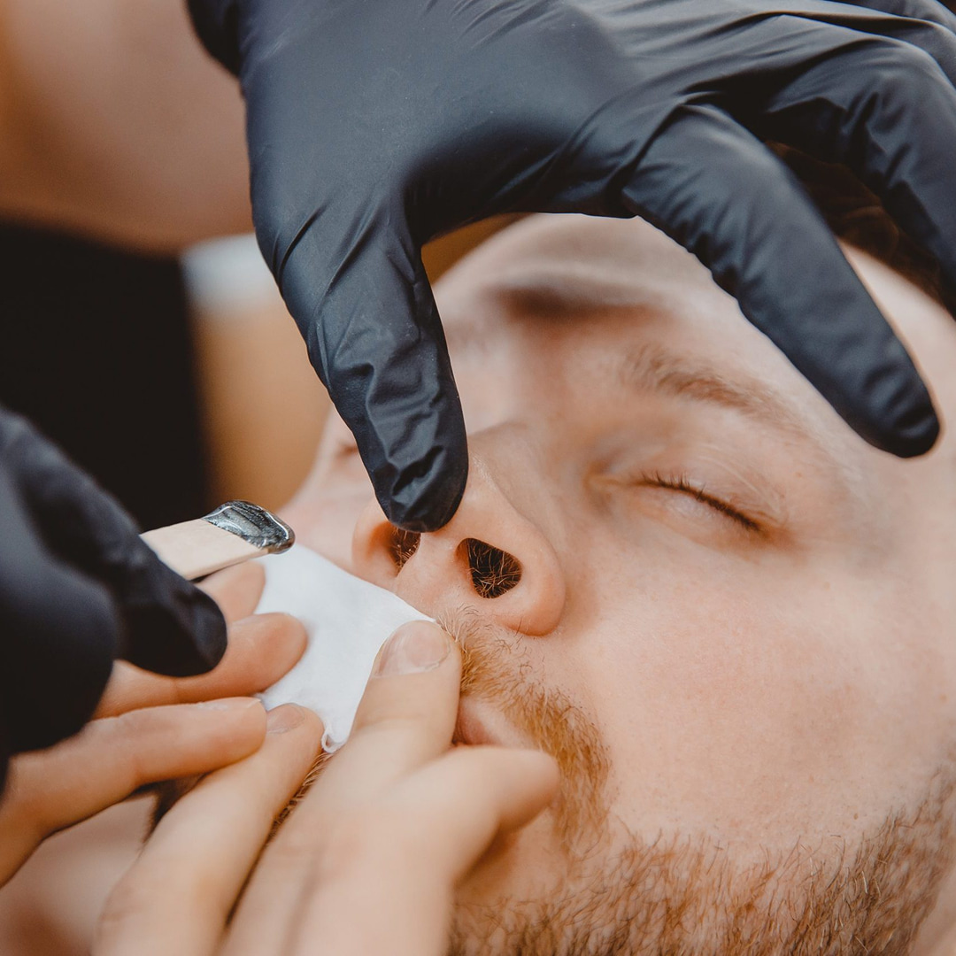 man having nose waxing