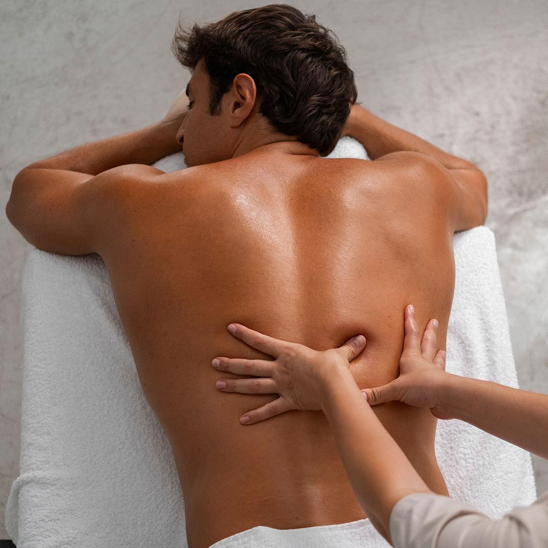 man getting a relaxing massage by professional masseuse