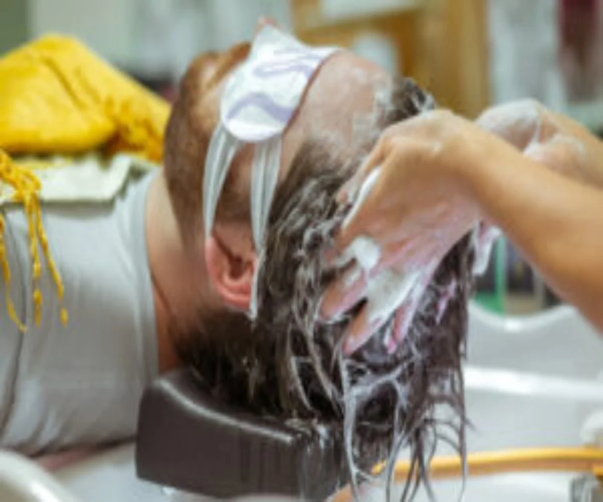 men having his hair washed in a reset men salon